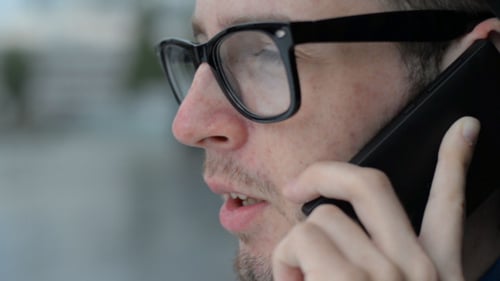Close up of Man Talking on Phone Outdoors