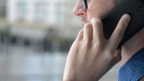 Man with Glasses Talking on Mobile Phone