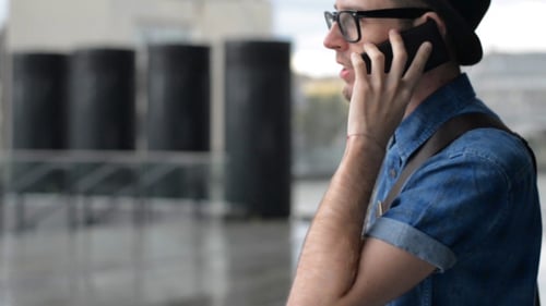 Young Adult Chatting on Phone in Urban Setting
