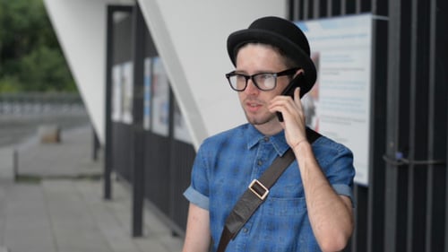 Young Man Talking on Smartphone in Urban Setting
