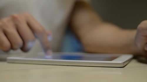 Hands Interact with Tablet Device Indoors