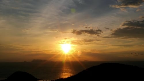 Scenic View Of Island At Sunset With Sea And
