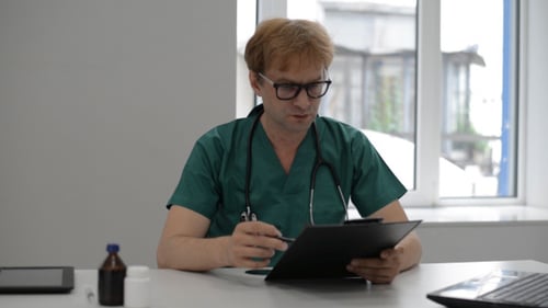 Doctor Reading Medical Report