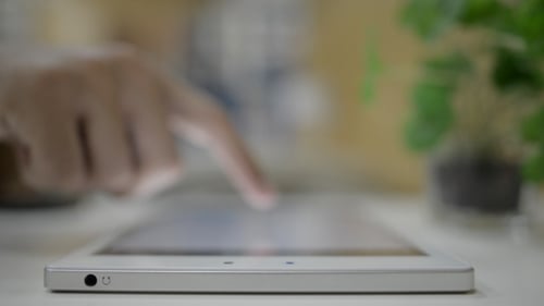 Finger Interacting With a Tablet Touchscreen