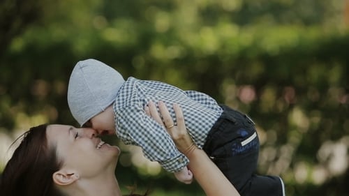Happy Baby Boy Playing With Mother In The Park