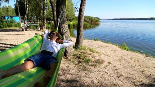 Man Relaxing in a Hammock