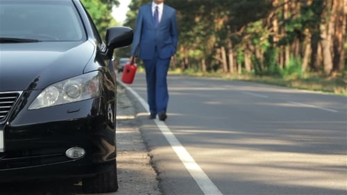 Businessman On The Road With a Jerrycan
