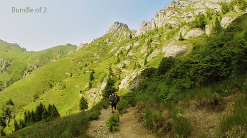Hikers Walking Along Mountain Trail on a Sunny Day