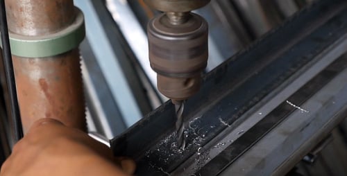 Drill Boring a Hole in Metal Beam