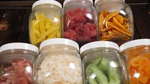 Dried Fruits in Glass Jars on Wood Surface