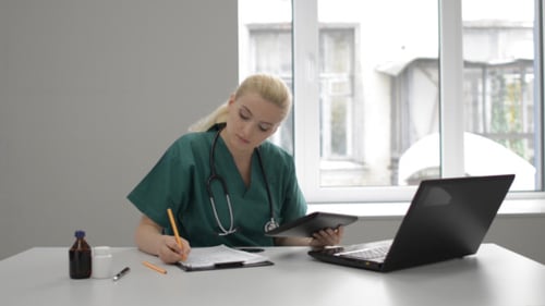 Lady Doctor Working in Clinic with Tablet