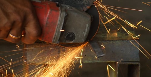 Cutting Wheel Slices Metal with Hot Sparks