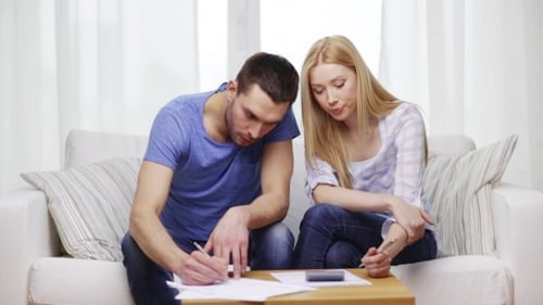 Young Couple Reviewing Finances at Home Together
