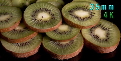 Fresh Green Kiwi Fruit Slices on Black Background
