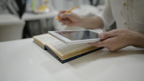 Studying with Tablet and Book at Desk