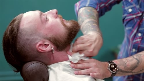 Barber Wiping Mans Neck After Shaving