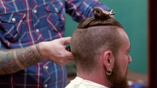 Beard Barber Making Haircut To Hipster Client