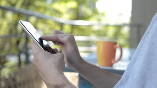 Close Up of Phone Use on Balcony
