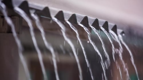 Rain Cascading Down From Metal Roof