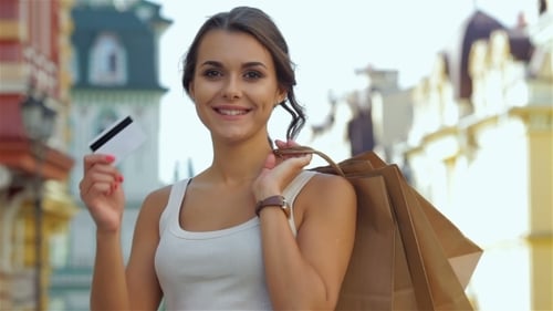 Young Woman with Credit Card and Shopping Bags