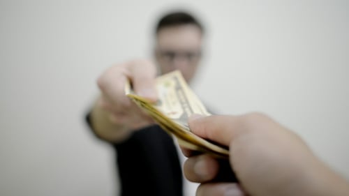 Handing Money to Camera