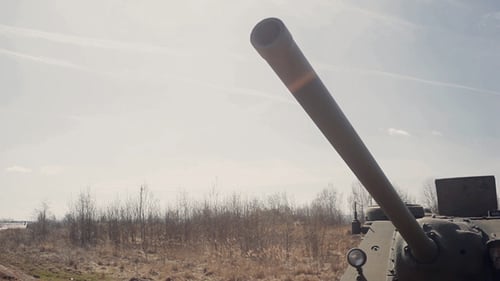 Vintage Military Tank Sits in Field on Clear Day