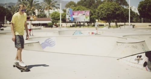 Young Adult Skateboarding in a Sunny Urban Skatepark