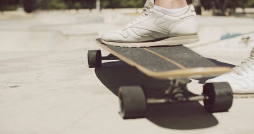 Person Standing on Skateboard in Skatepark