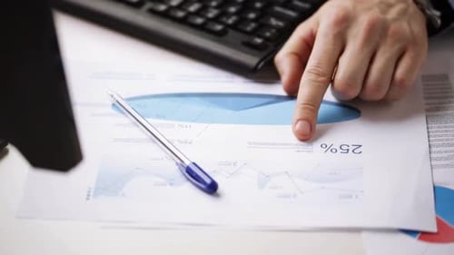 Close Up Of Male Hands With Charts And Keyboard 1