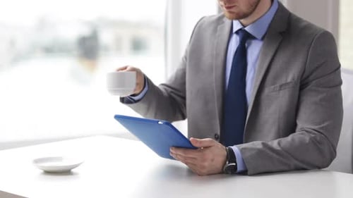Close Up Of Man With Tablet Pc Drinking Coffee 1