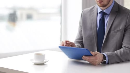 Close Up Of Man With Tablet Pc Drinking Coffee 2