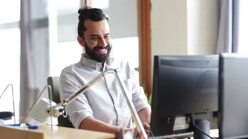 Happy Creative Male Office Worker With Computer 1