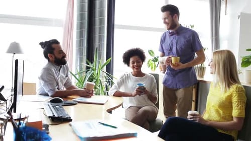 Happy Creative Team Drinking Coffee In Office 13