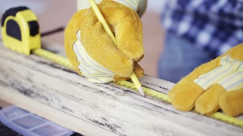 Close Up Of Man Hammering Nail To Wooden Board 11