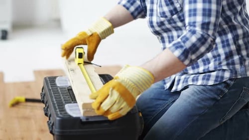 Close Up Of Man Hammering Nail To Wooden Board 4