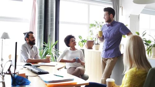 Happy Creative Team Drinking Coffee In Office 2