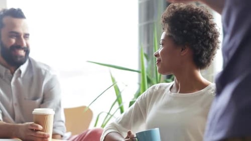 Happy Creative Team Drinking Coffee In Office 21