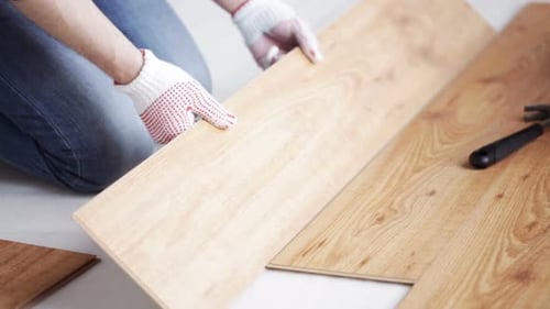 Close Up Of Man Installing Wood Flooring 11