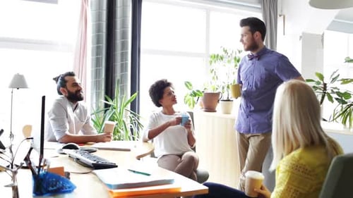 Happy Creative Team Drinking Coffee In Office 6