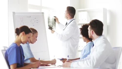 Group Of Doctors Looking At X-Ray In Hospital