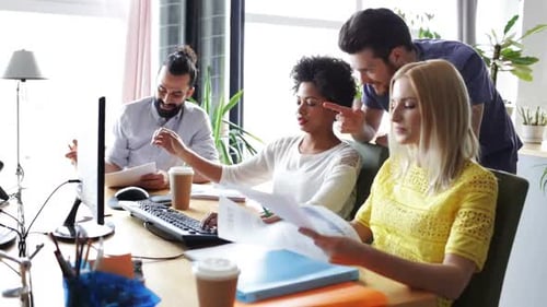 Equipe criativa feliz com computadores no escritório 12