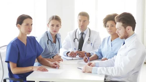 Group Of Doctors Meeting At Seminar In Hospital 6