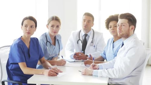 Group Of Doctors Meeting At Seminar In Hospital 7