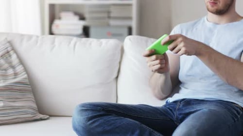 Close Up Of Man Playing Game On Smartphone At Home 2