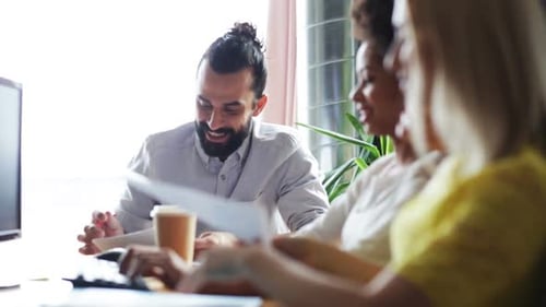 Happy Creative Team With Papers Talking In Office 2
