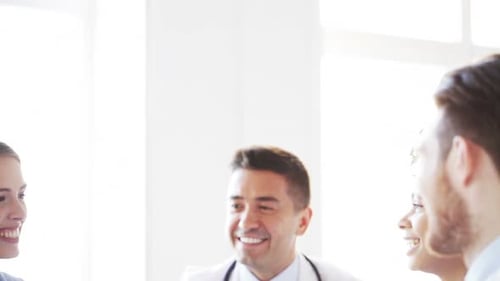 Group Of Happy Doctors Making High Five At Clinic 2