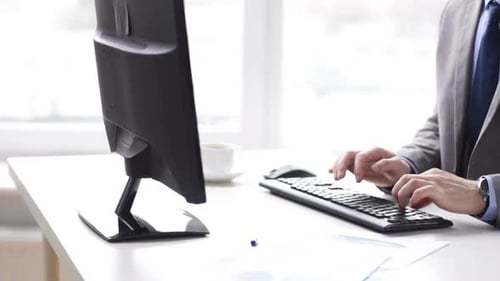 Close Up Of Businessman Typing And Drinking Coffee 2