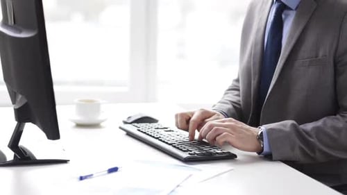 Close Up Of Businessman Typing And Drinking Coffee 3