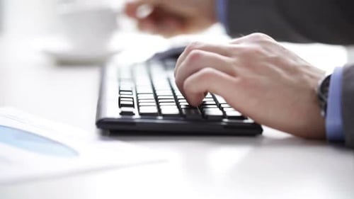 Close Up Of Businessman Typing And Drinking Coffee 5