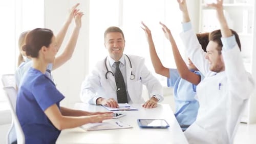 Group Of Happy Doctors With Hands On Top At Clinic 2